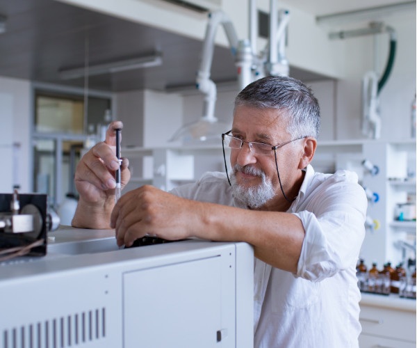 Man injecting sample into gas chromatograph