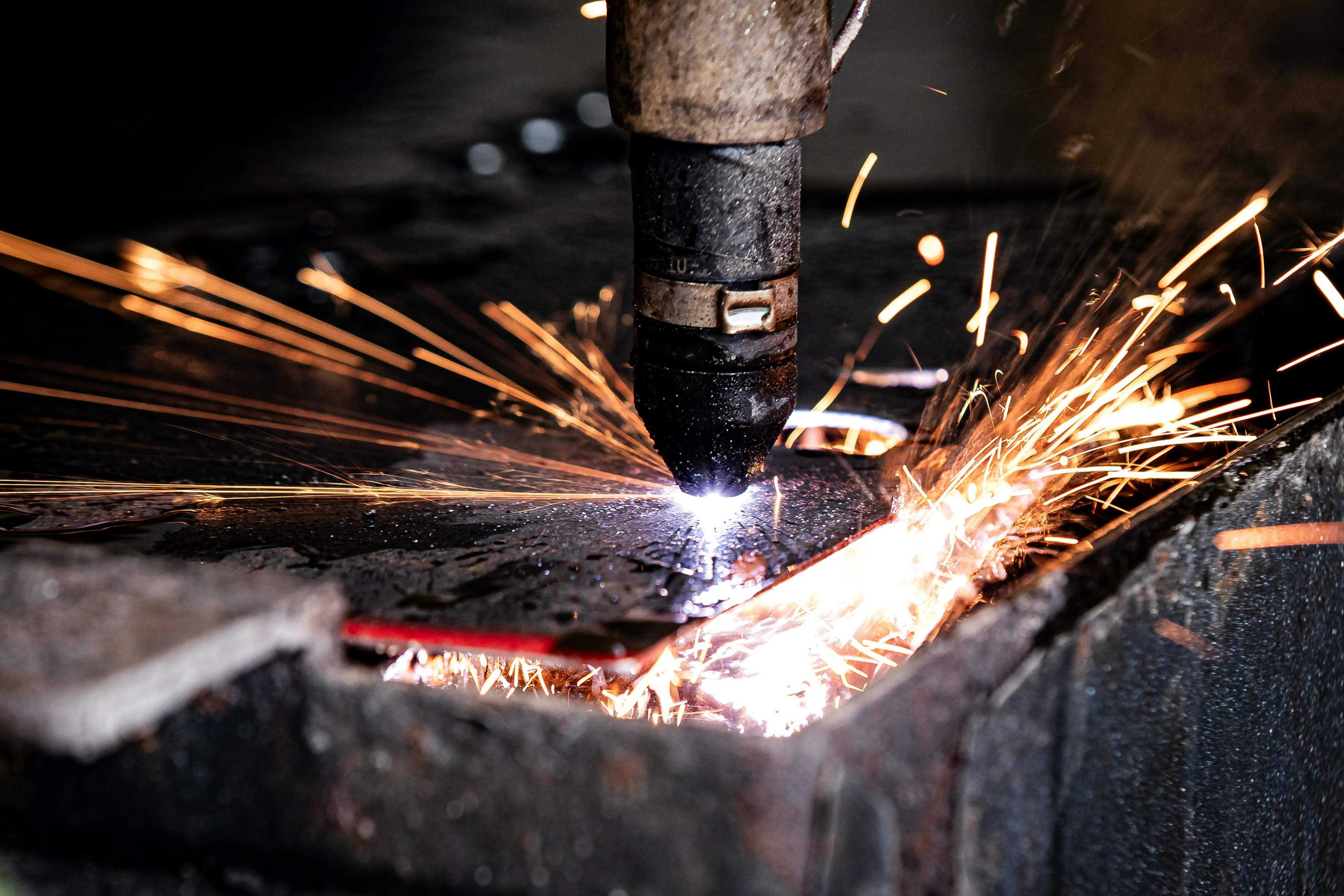 Close-up of metal cutting with intense sparks from a torch, showing fast pierce and cut speed.