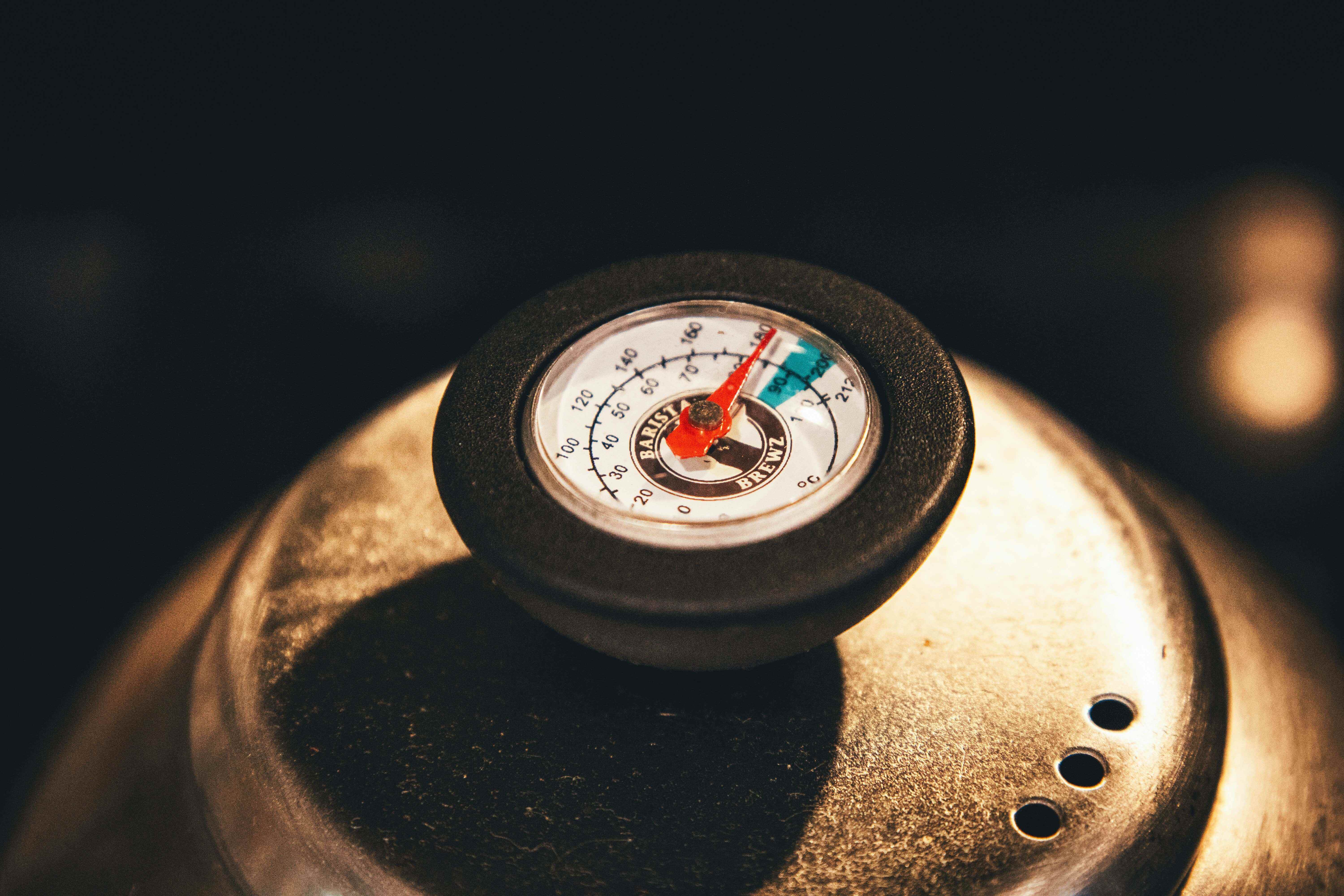 Laboratory thermometer with elevated temperature reading, illustrating flame stability and heat control.