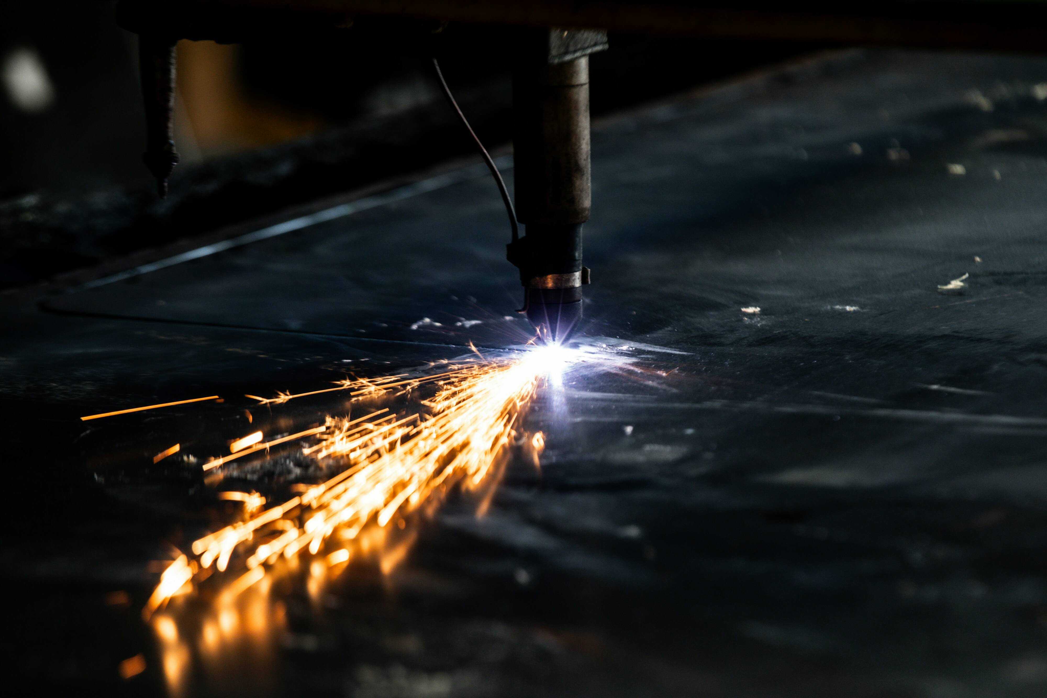Oxy-fuel cutting with bright sparks after lines were purged with industrial nitrogen for safety.